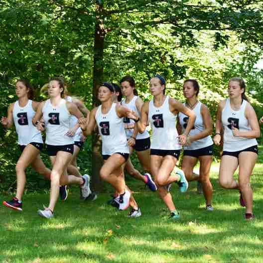 Lady Ravens cross country team running in a pack