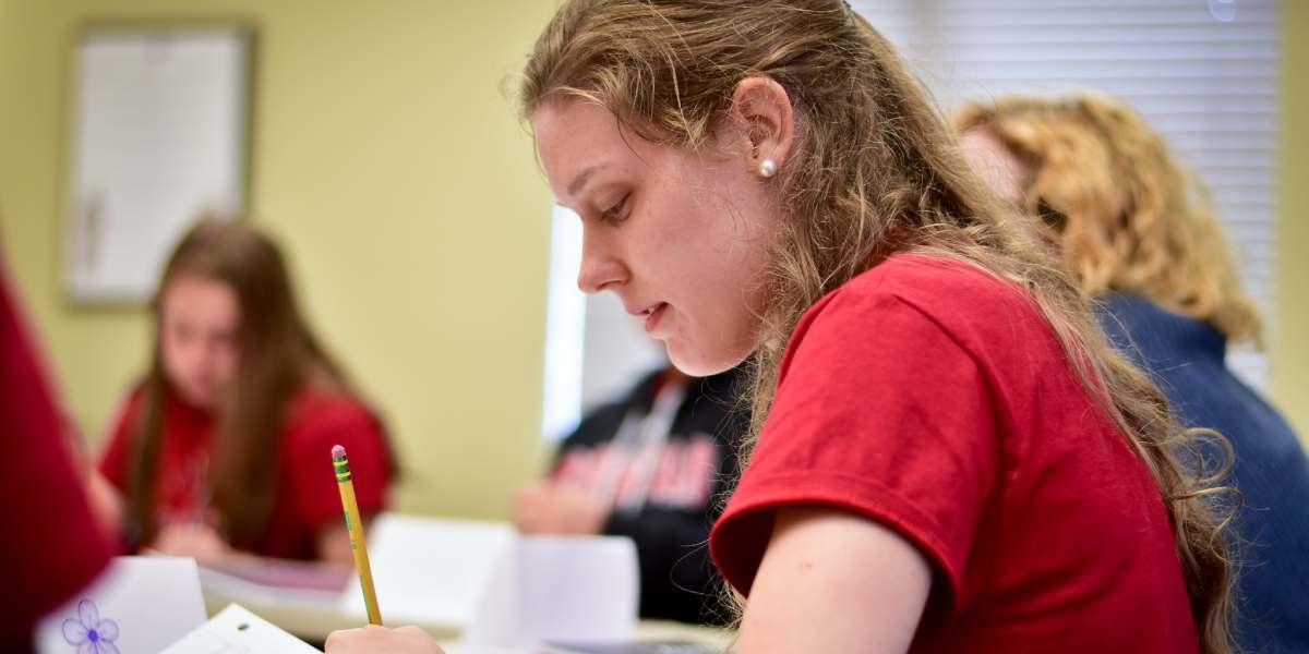 A BCYC Immersion student taking notes in class